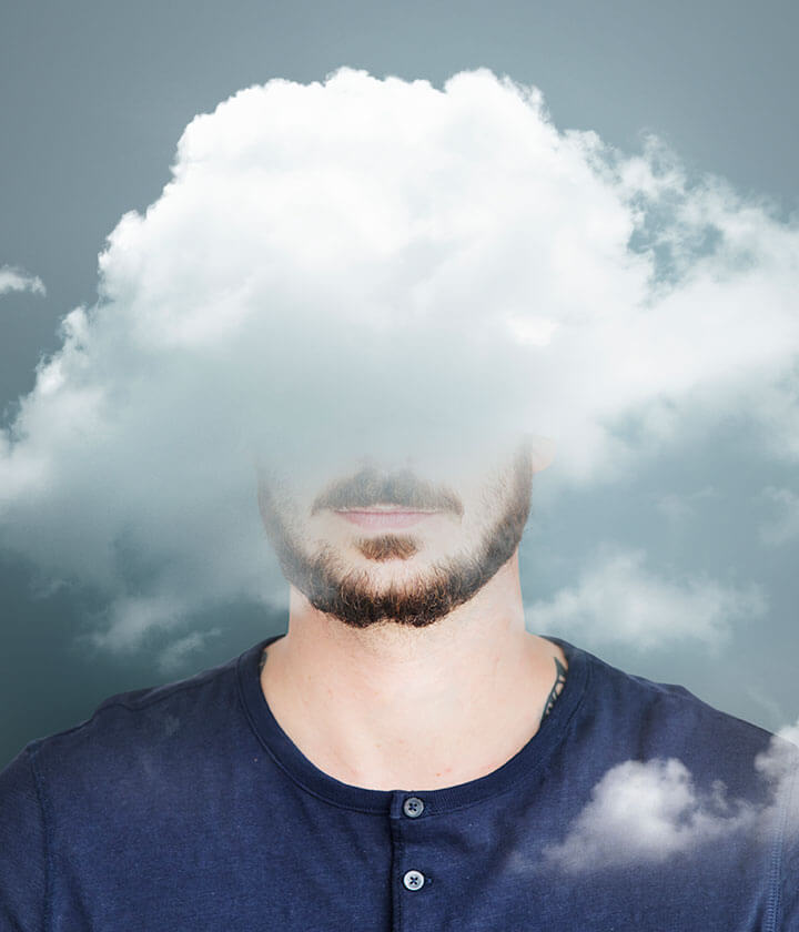 A cloud obscuring the head of a person against a blue background.
