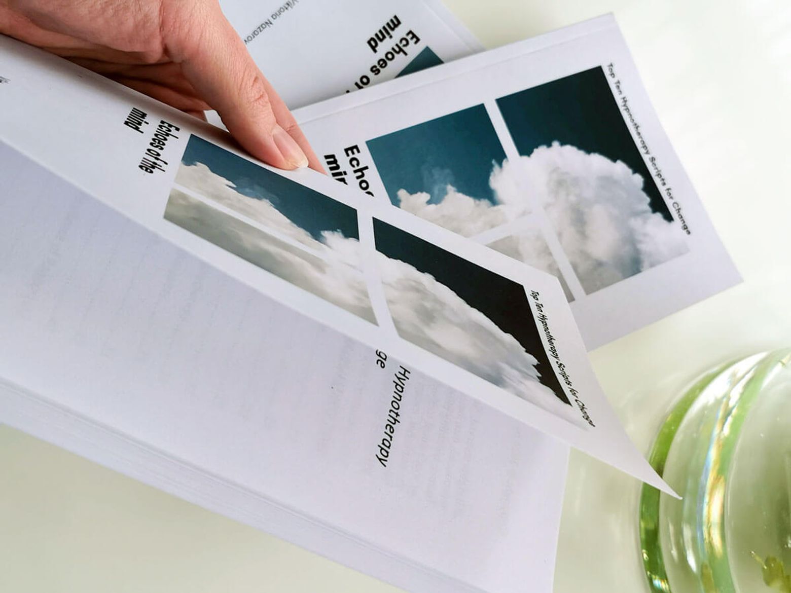 A hand turning the pages of Top Ten Hypnotherapy Scripts for Change.