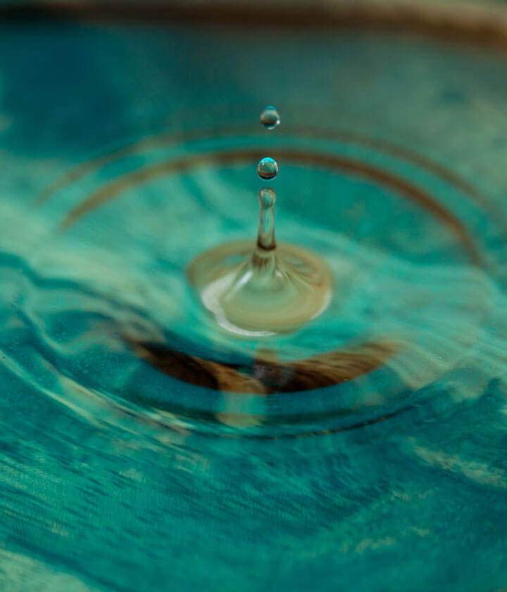 A drop of water creating circular ripples.