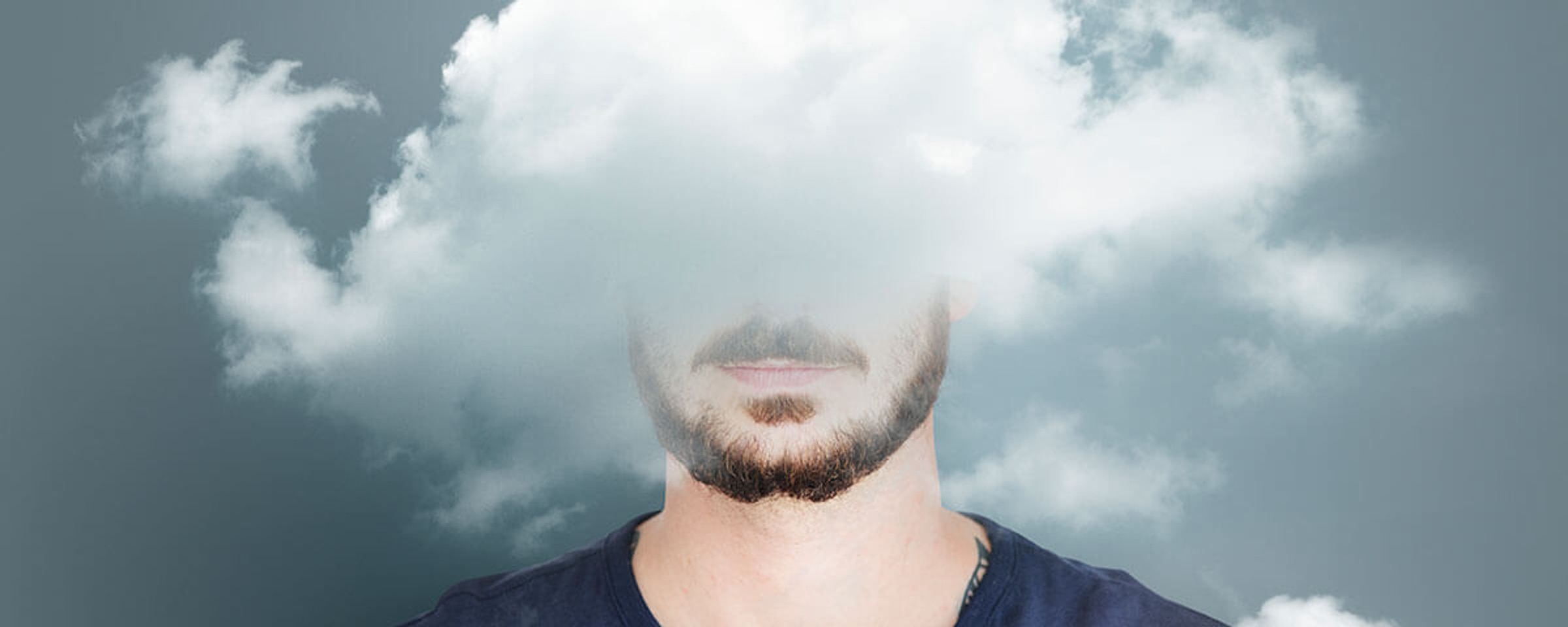 A cloud obscuring the head of a person against a blue background.